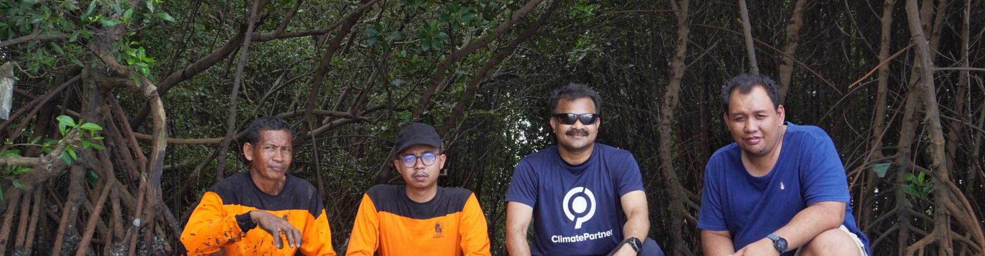 Group of people squatting in mangroves