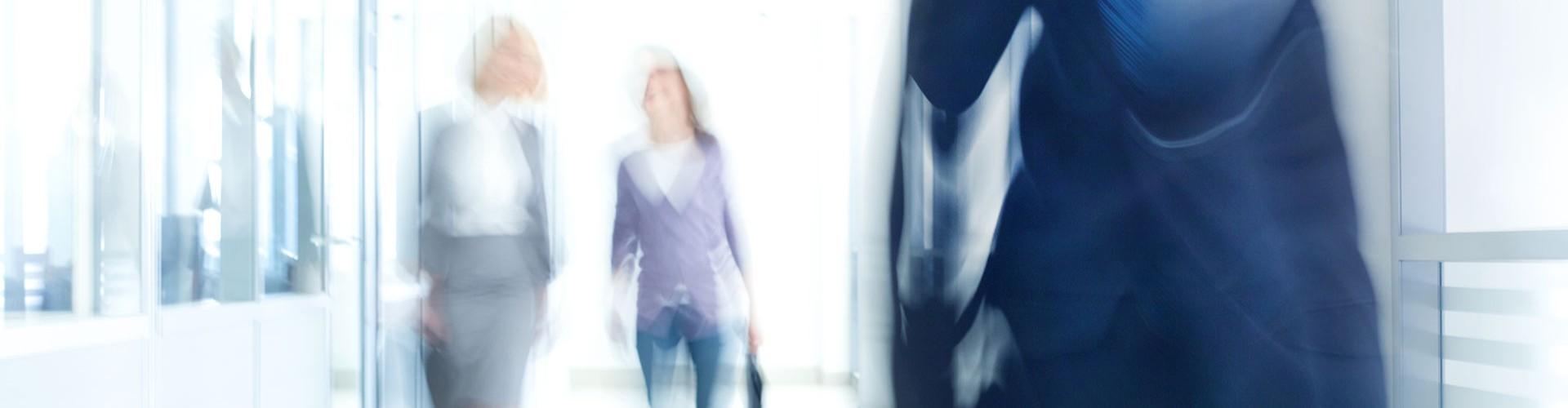 Business people walking along a halway